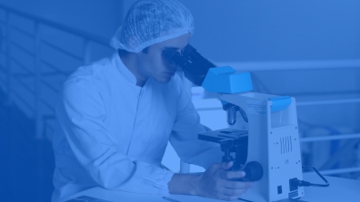 Man looking through microscope