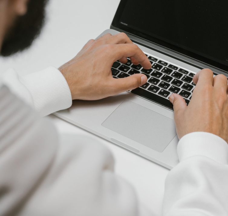 Man with hands on a laptop keyboard
